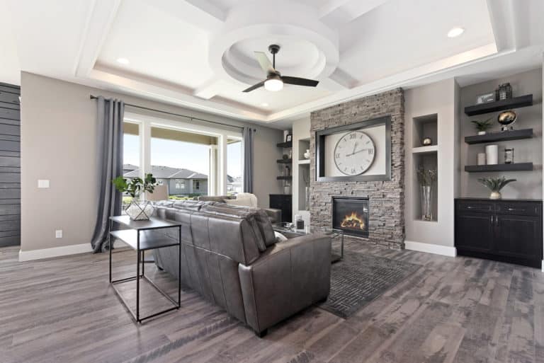 Great room with stone wrapped fireplace and custom built-ins